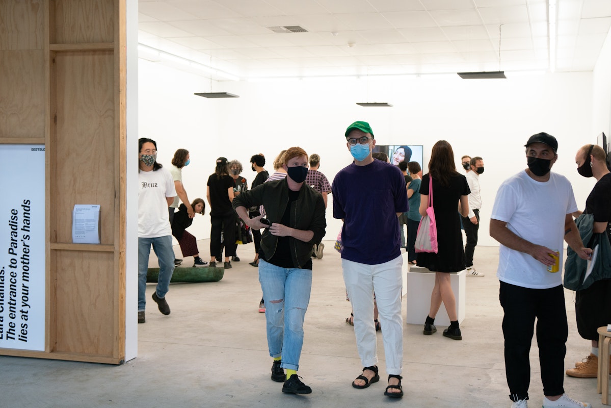 Visitors at the opening of Lara Chamas, The entrance to Paradise lies at your mother's hands, 2021, at Gertrude Contemporary. Photo: Machiko Abe