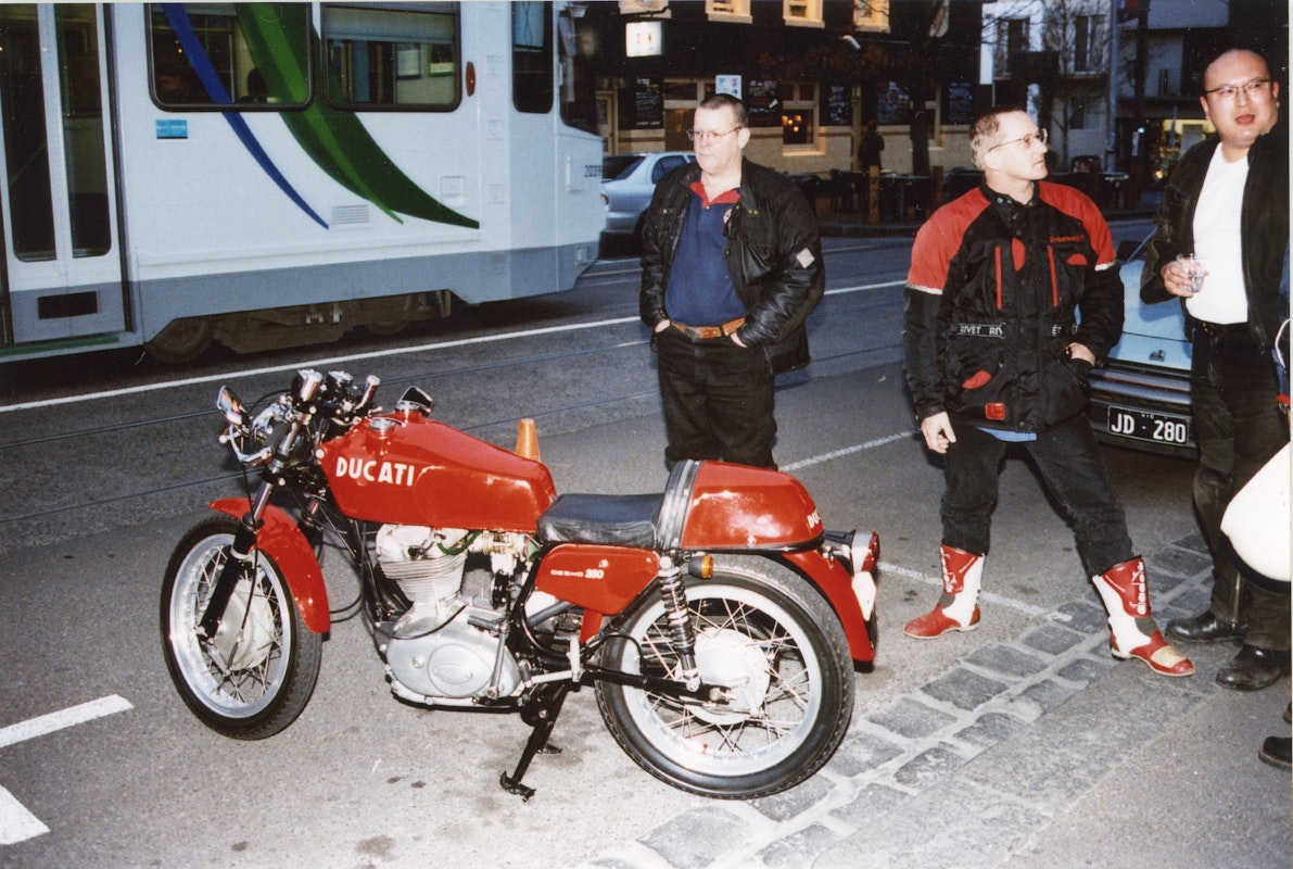Audiences attend Simone LeAmon, MOTO Showroom, with performance riders from the Moto Guzzi motorcycle club, presented at Gertrude Contemporary Art Spaces, 2003. Courtesy of the artist and the Gertrude Archive.