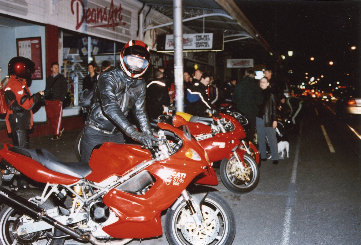 Audiences attend Simone LeAmon, MOTO Showroom, with performance riders from the Moto Guzzi motorcycle club, presented at Gertrude Contemporary Art Spaces, 2003. Courtesy of the artist and the Gertrude Archive.