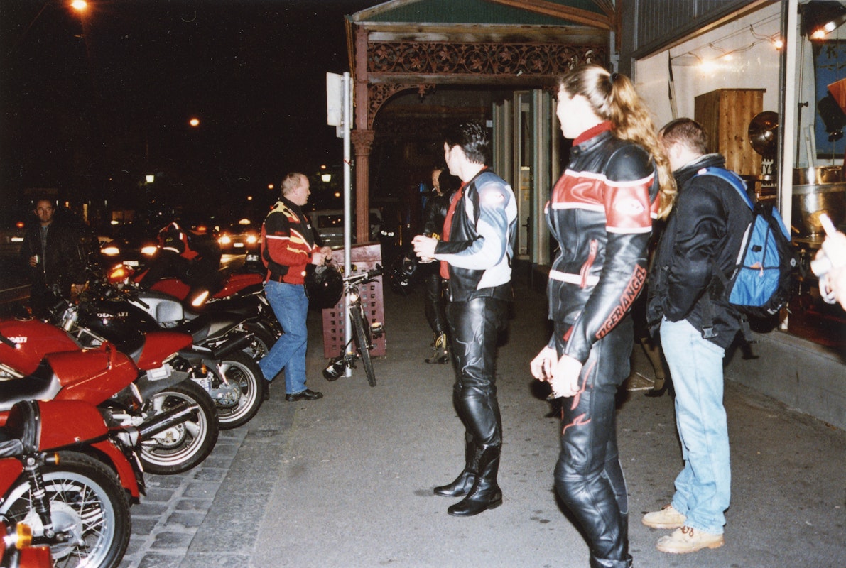 Audiences attend Simone LeAmon, MOTO Showroom, with performance riders from the Moto Guzzi motorcycle club, presented at Gertrude Contemporary Art Spaces, 2003. Courtesy of the artist and the Gertrude Archive.