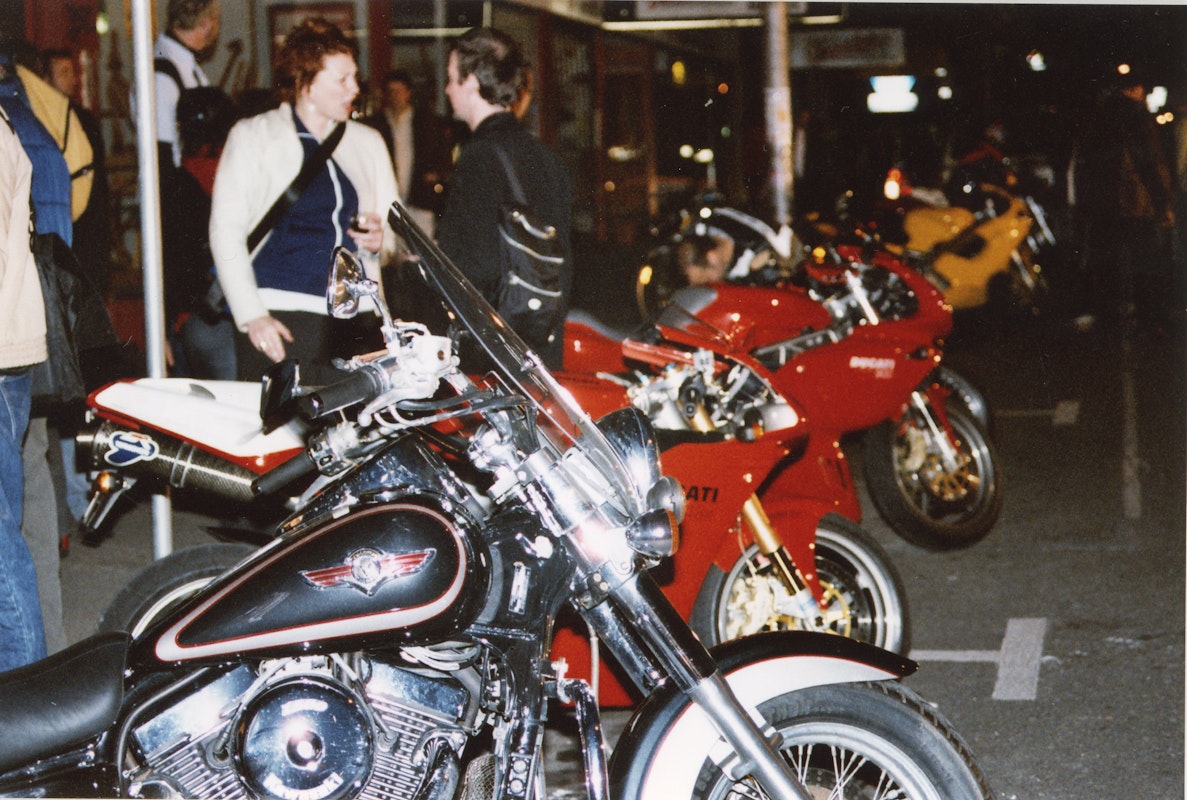 Audiences attend Simone LeAmon, MOTO Showroom, with performance riders from the Moto Guzzi motorcycle club, presented at Gertrude Contemporary Art Spaces, 2003. Courtesy of the artist and the Gertrude Archive.