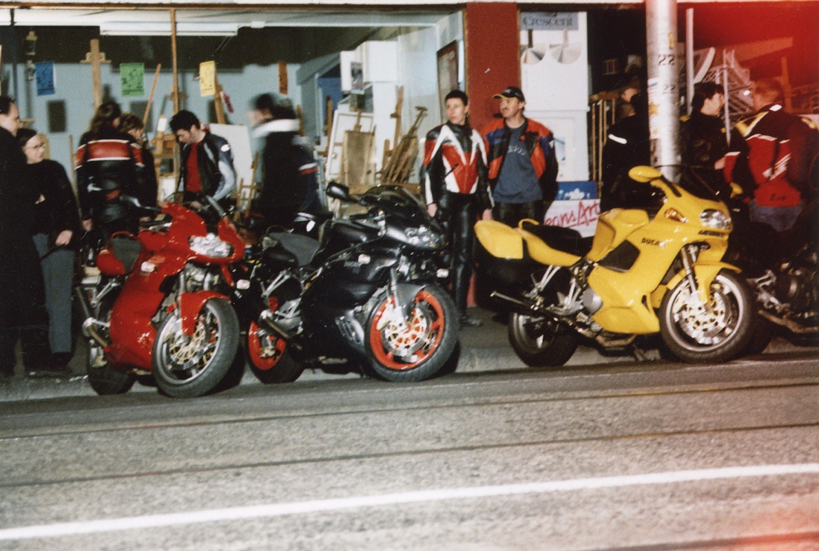 Audiences attend Simone LeAmon, MOTO Showroom, with performance riders from the Moto Guzzi motorcycle club, presented at Gertrude Contemporary Art Spaces, 2003. Courtesy of the artist and the Gertrude Archive.