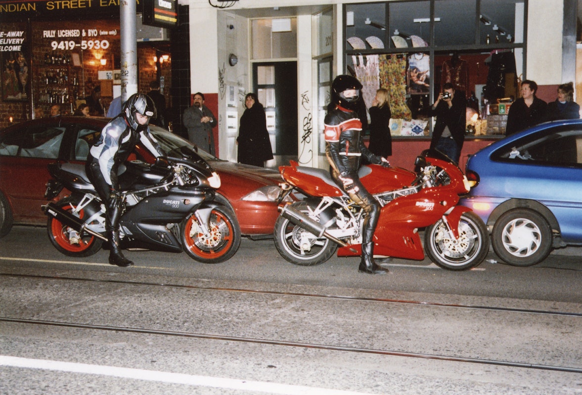 Audiences attend Simone LeAmon, MOTO Showroom, with performance riders from the Moto Guzzi motorcycle club, presented at Gertrude Contemporary Art Spaces, 2003. Courtesy of the artist and the Gertrude Archive.
