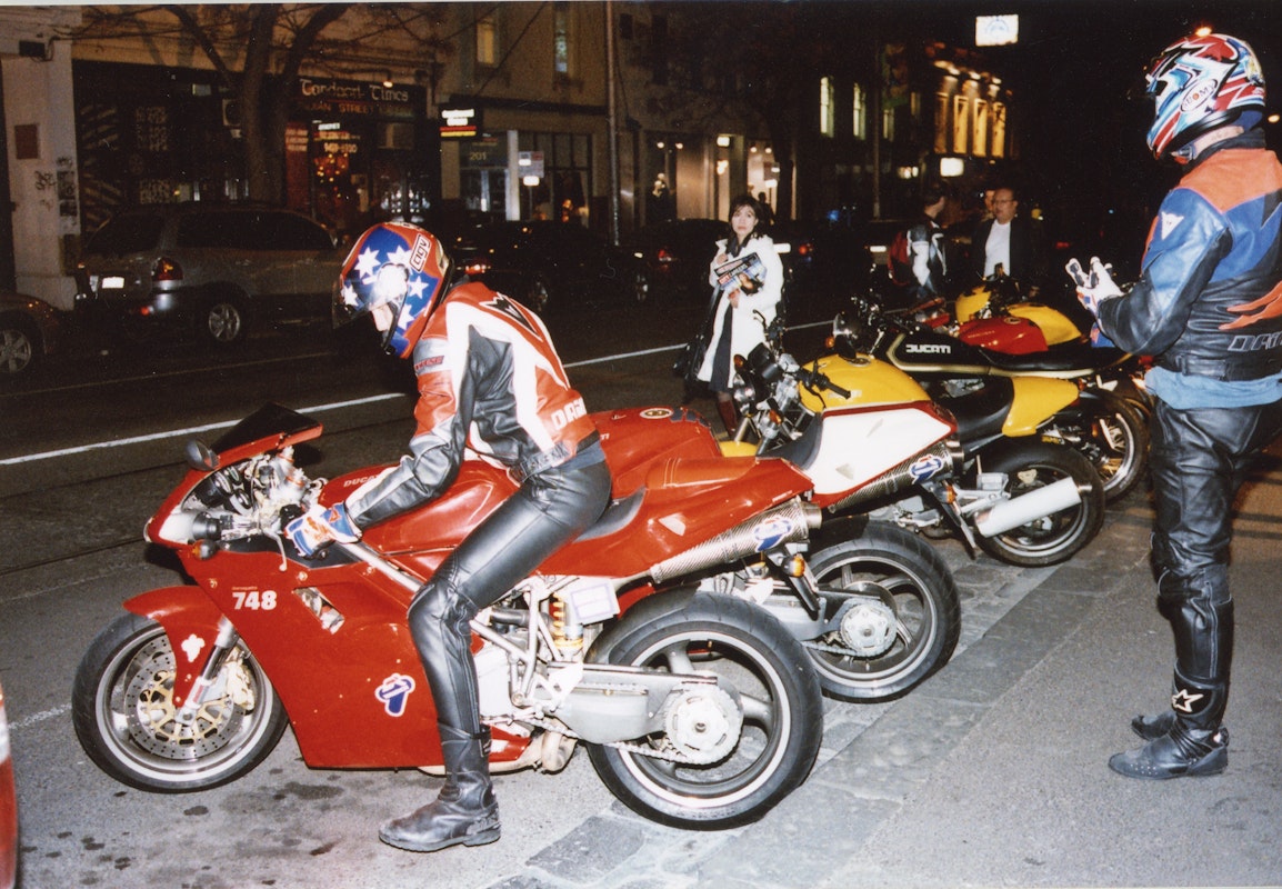 Audiences attend Simone LeAmon, MOTO Showroom, with performance riders from the Moto Guzzi motorcycle club, presented at Gertrude Contemporary Art Spaces, 2003. Courtesy of the artist and the Gertrude Archive.