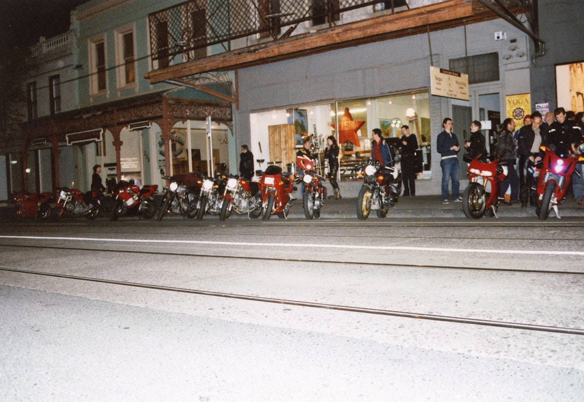 Audiences attend Simone LeAmon, MOTO Showroom, with performance riders from the Moto Guzzi motorcycle club, presented at Gertrude Contemporary Art Spaces, 2003. Courtesy of the artist and the Gertrude Archive.