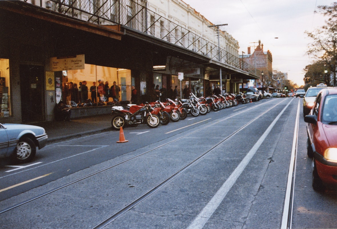 Audiences attend Simone LeAmon, MOTO Showroom, with performance riders from the Moto Guzzi motorcycle club, presented at Gertrude Contemporary Art Spaces, 2003. Courtesy of the artist and the Gertrude Archive.