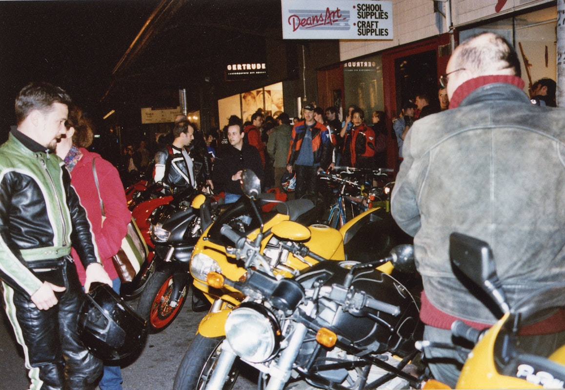Audiences attend Simone LeAmon, MOTO Showroom, with performance riders from the Moto Guzzi motorcycle club, presented at Gertrude Contemporary Art Spaces, 2003. Courtesy of the artist and the Gertrude Archive.