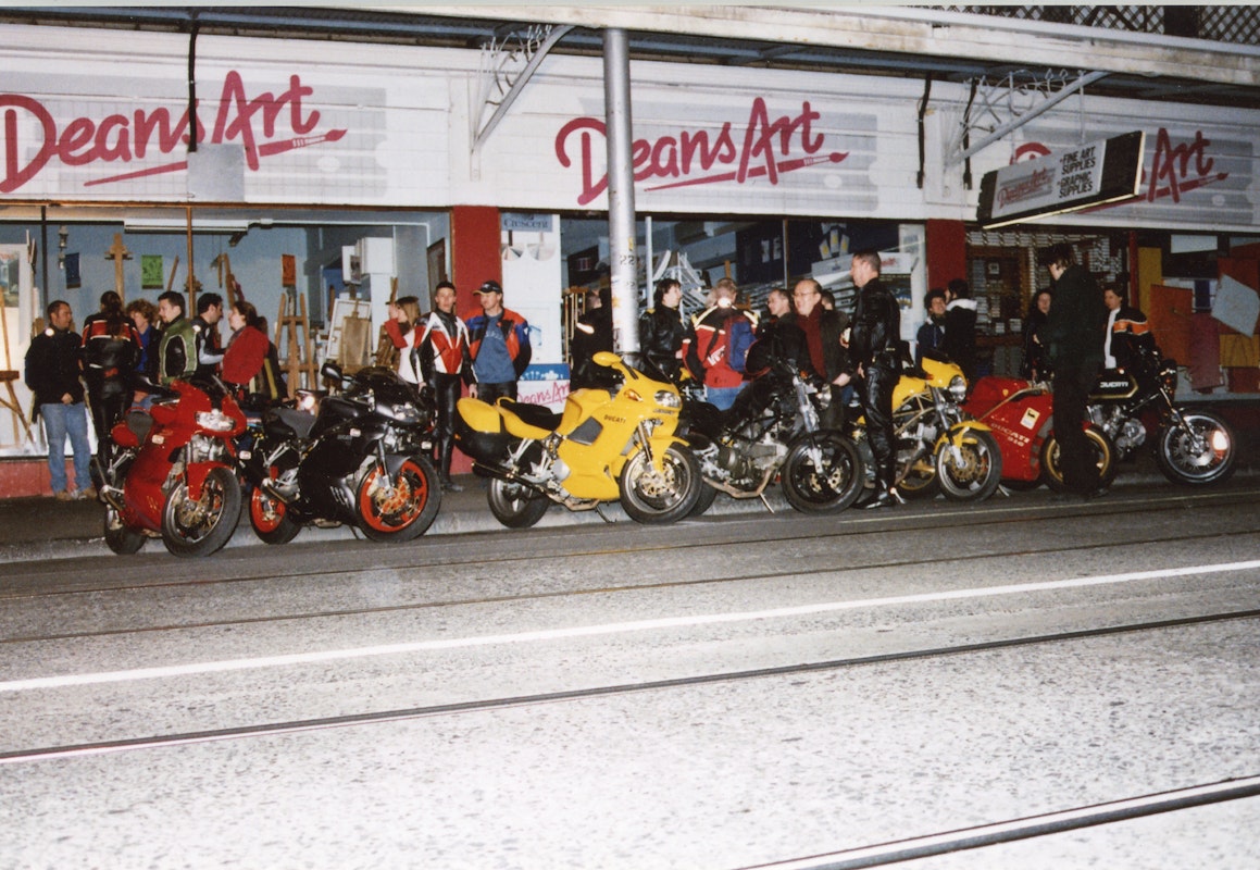 Audiences attend Simone LeAmon, MOTO Showroom, with performance riders from the Moto Guzzi motorcycle club, presented at Gertrude Contemporary Art Spaces, 2003. Courtesy of the artist and the Gertrude Archive.