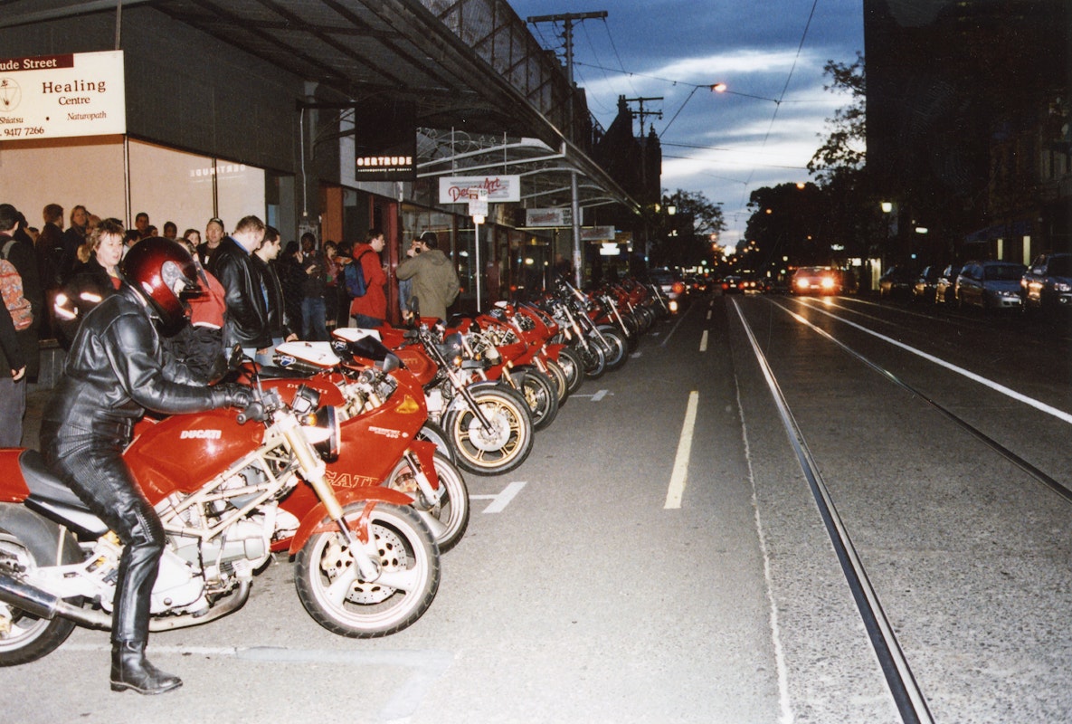 Audiences attend Simone LeAmon, MOTO Showroom, with performance riders from the Moto Guzzi motorcycle club, presented at Gertrude Contemporary Art Spaces, 2003. Courtesy of the artist and the Gertrude Archive.
