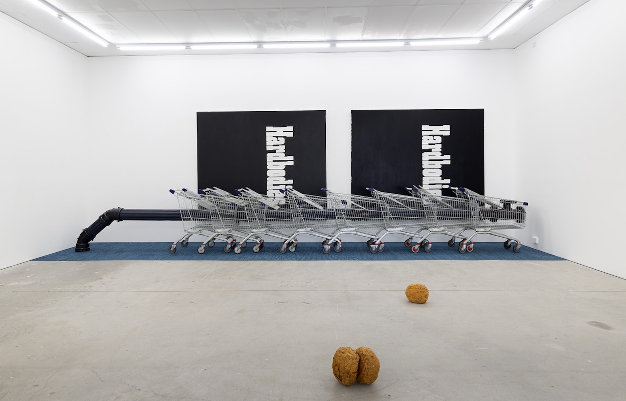 Alexandra Peters, Bottleneck, 2024: Foreign Line Extraction IV (Mains), 2024, vinyl, polyurethane ‘open cell’ foam and pine, enamel on ductile iron, acrylic, shopping trollies, Leg Over Leg, 2024, commercial carpet tiles, Hardbodies I, 2024, acrylic on canvas, Hardbodies II, 2024, acrylic on canvas; Erin Hallyburton, Oilstones (detail), 2024, instant batter mix, water, vegetable oil, installation view, And This Time the Well Is Alive, Gertrude Contemporary, Naarm Melbourne, 2024, image courtesy and © the artists, photograph: Christian Capurro