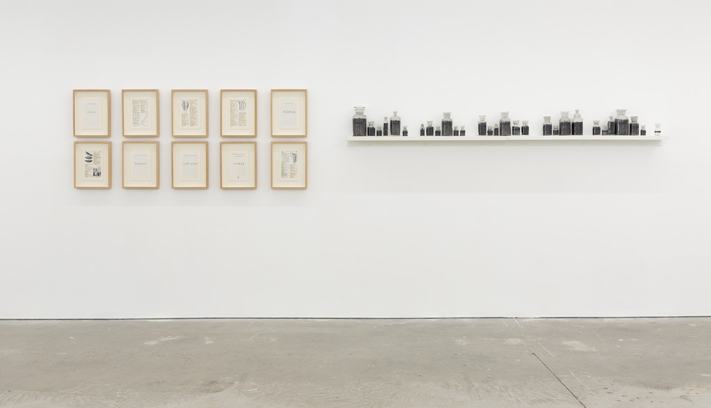 Jenna Lee, Aboriginal Words and Place Names, 2022, pages from Aboriginal Words and Place Names, fire; Jenna Lee, article-particle (Guyu-Gwa), 2023-2024, various pigment jars, pages of Aboriginal Words and Place Names, fire, labels, installation view, Gertrude Studios, Gertrude Contemporary, Naarm Melbourne, 2024, image courtesy and © the artist and MARS Gallery, Naarm Melbourne, photograph: Christian Capurro.