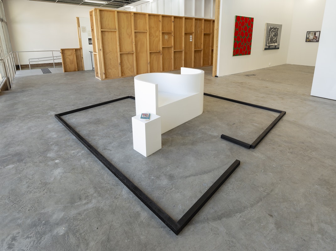 Gail Hastings, Room for Love, 1990, reconstructed 2005, tête-à-tête conversation chair and plinths, acrylic paint on wood; Loveswept edition paperback novels; pigmented wax on timber, installation view, A Fictional Retrospective: Gertrude’s First Decade 1985–1995, Gertrude Contemporary, Naarm Melbourne, 2025, image courtesy and © the artist, photograph: Christian Capurro