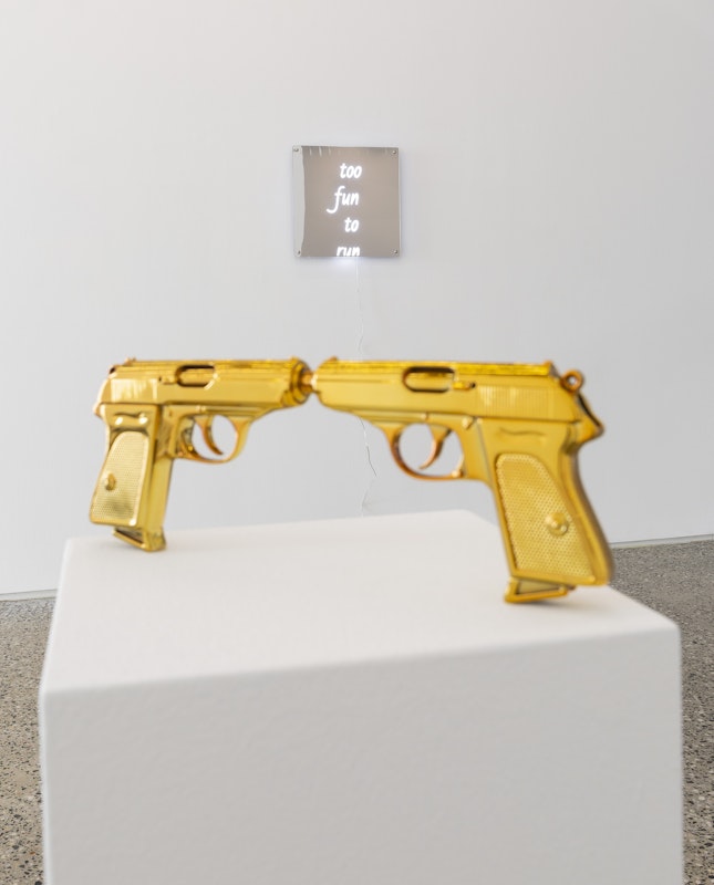 Chunxiao Qu, We Kissed, 2025, photopolymer resin, polished metallic gold finish, 30 x 10.8 x 2.2 cm; and too fun to run, LED neon with transparent acrylic frames, 45 x 45 cm, courtesy of the artist and FUTURES, Naarm Melbourne, installation view, Gertrude Glasshouse, Naarm Melbourne, 2025, photography: Christian Capurro