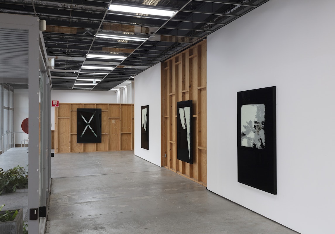 Foster Berean, Untitled from the series Low Expectations 2008, installation view, Of Stadiums and Construction Sites (Ne change rien pour que tout soit différent), Gertrude Contemporary, Naarm Melbourne, 2025, enamel and paper on glass, image courtesy and © the artists, photograph: Christian Capurro