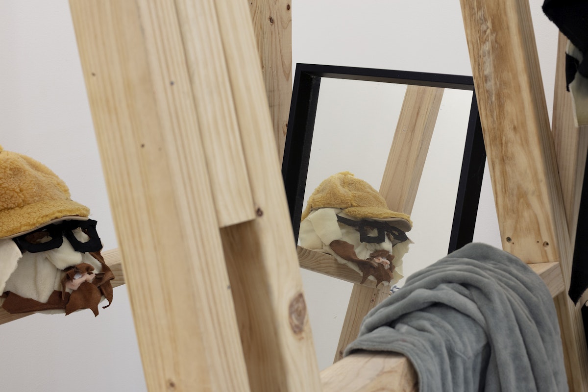 Ardi Gunawan, luckily there’s no inside (brick Muppet filth face anxiety ladder. Emotion traffic re-enactment Jakarta body) 2011/2025, installation view, Of Stadiums and Construction Sites (Ne change rien pour que tout soit différent), Gertrude Contemporary, Naarm Melbourne, 2025, performance, synthetic fur, foam, fabric, cardboard, found objects, digital print mounted on kappa board, timber structures repurposed from previous exhibition build, image courtesy the artist as ISA Gallery, Jakarta © the artist, photograph: Christian Capurro