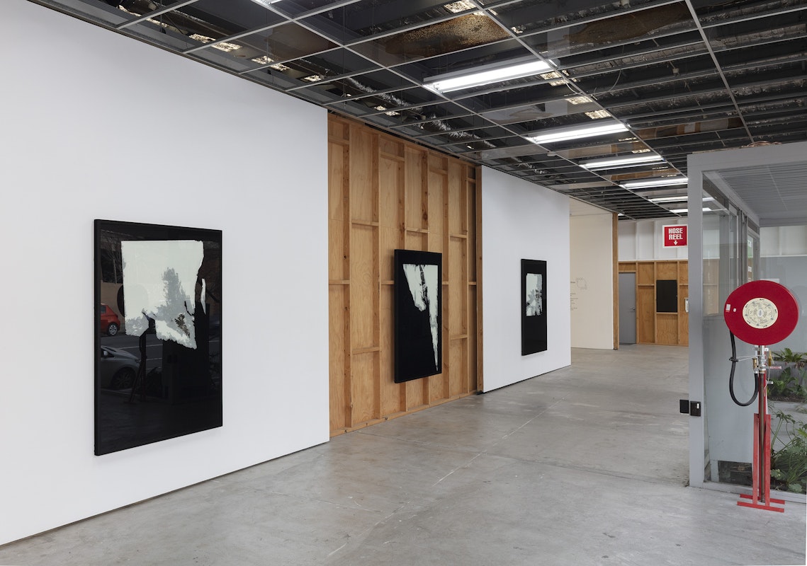 Foster Berean, Untitled from the series Low Expectations 2008, installation view, Of Stadiums and Construction Sites (Ne change rien pour que tout soit différent), Gertrude Contemporary, Naarm Melbourne, 2025, enamel and paper on glass, image courtesy and © the artists, photograph: Christian Capurro