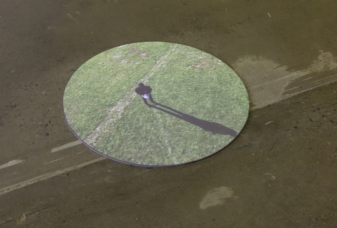 Aaron Rees, Telechiric Loop, 2015, installation view, installation view, Of Stadiums and Construction Sites (Ne change rien pour que tout soit différent), Gertrude Contemporary, Naarm Melbourne, 2025, HD projection onto acrylic, video on monitor, image courtesy and © the artist, photograph: Christian Capurro