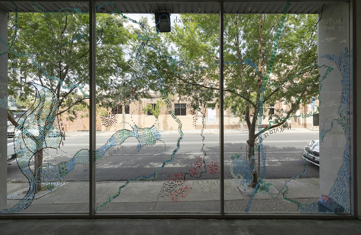 Renee Cosgrave in collaboration with Akuira, Amorangi, Jasmine Morrish, Rachel Boyd, Angela Cooper-Naresh, Anahera Neho-Cooper, Waru Cooper, Christo Crocker, Lisa Manawa Grocott, Helena Hapeta, Bronwyn Kara, Julien Te Purei Comer-Kleine, Errol MacKinven Hunt, Heneriata Paringatai, Watere Tahi, Irihipeti Waretini and our Kirrip (Bun Wurrung Balug), Ngā awa whina o te whakapapa (The braided rivers of whakapapa), 2025, installation view, Various Small Fires, Gertrude Contemporary, Naarm Melbourne, 2025, acrylic and chalk on window, image courtesy and © the artists, photograph: Christian Capurro