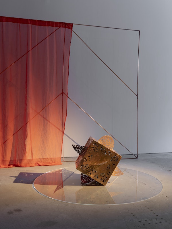 Shireen Taweel, unknown arcs of a sphere VI, 2026, engraved and pierced copper; unknown arcs of a sphere XIV, 2026, copper pipe, red clay dyed muslin and 3D printed brackets, installation view, pacing seven circles, Gertrude Contemporary, Naarm Melbourne, 2026, image courtesy of the artist and STATION, Naarm Melbourne and Sydney © the artist, photograph: Christian Capurro