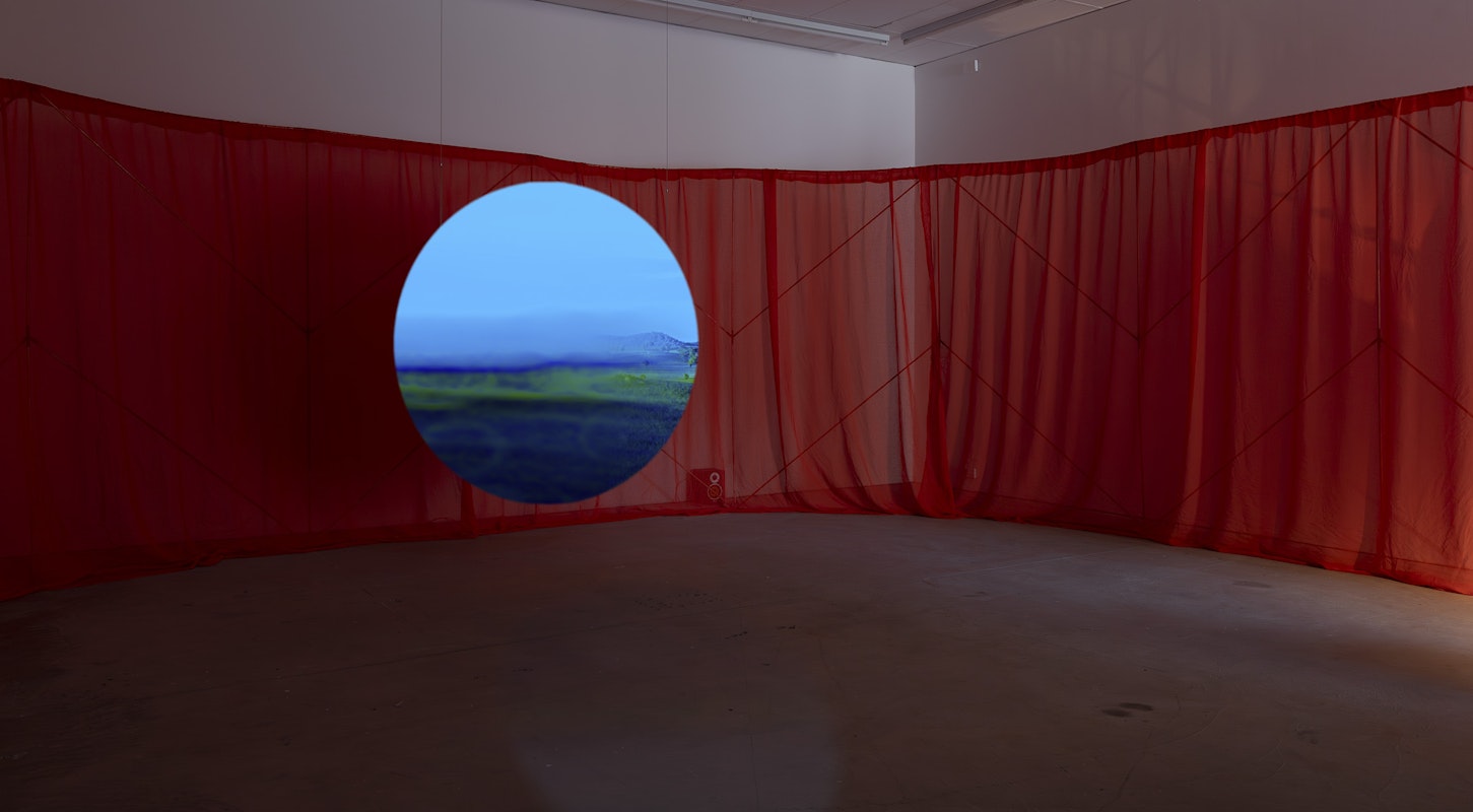 Shireen Taweel, unknown arcs of a sphere IX, 2026, single-channel digital video, colour, sound, unknown arcs of a sphere XIV, 2026, copper pipe, red clay dyed muslin and 3D printed brackets, installation view, pacing seven circles, Gertrude Contemporary, Naarm Melbourne, 2026, image courtesy of the artist and STATION, Naarm Melbourne and Sydney © the artist, photograph: Christian Capurro