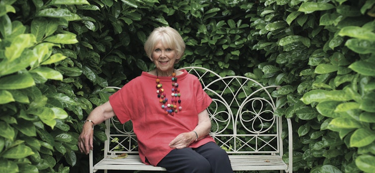 Wendy Craig sitting on a bench
