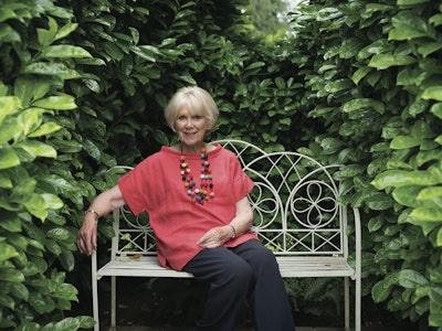 Wendy Craig sitting on a bench