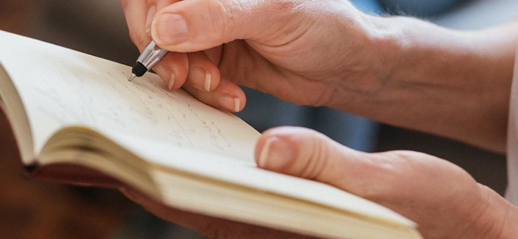 Lady writing in a notebook
