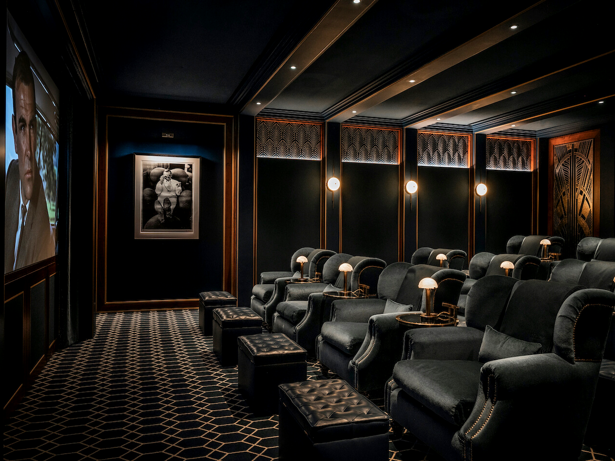 Cinema with velvet armchairs and footstools