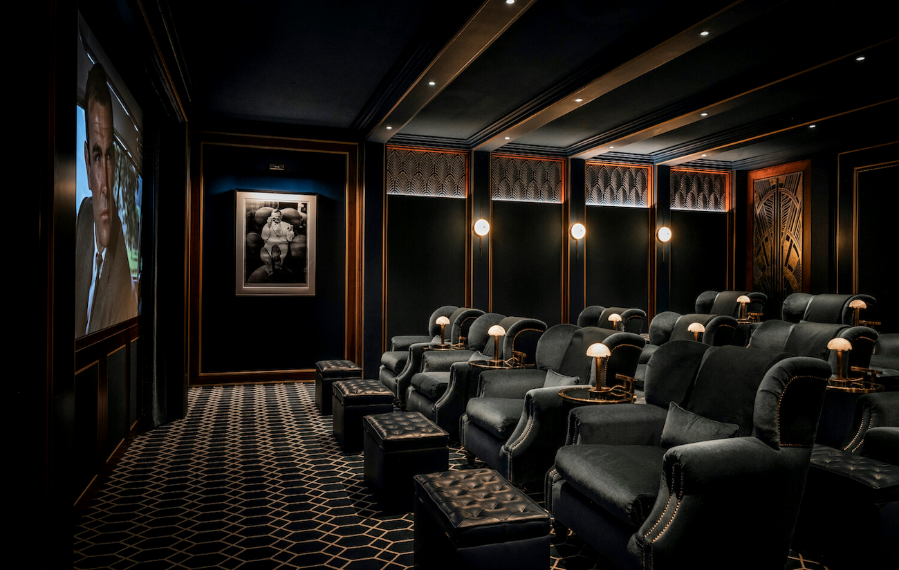 Cinema with velvet armchairs and footstools