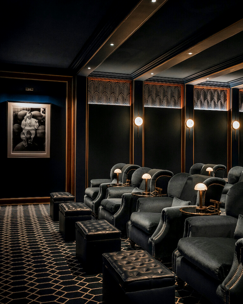Cinema with velvet armchairs and footstools