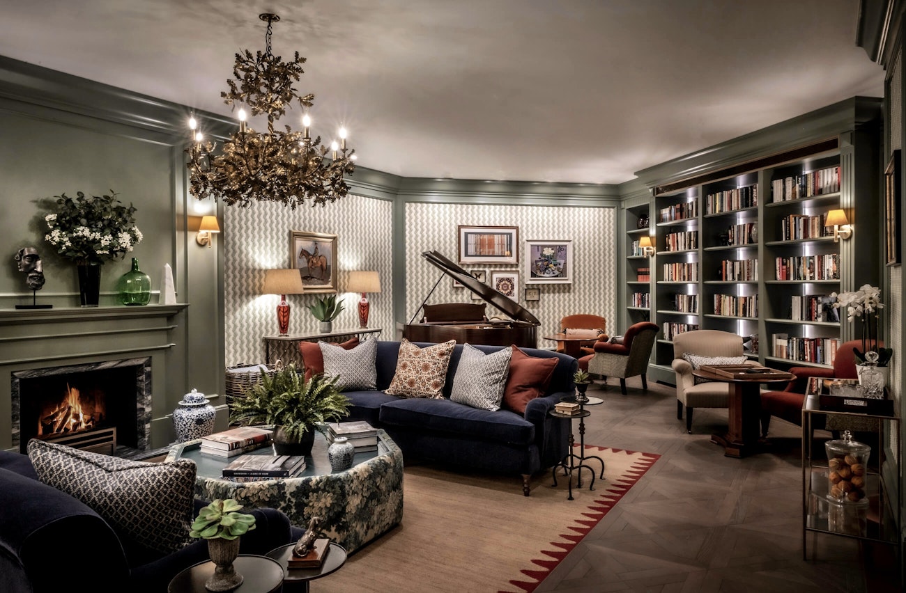 Library with bookshelves and fireplace
