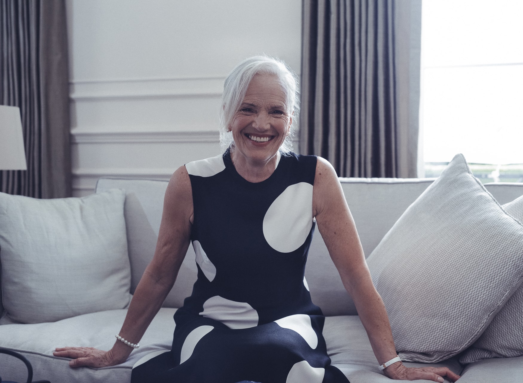 Smiling lady sitting on the sofa