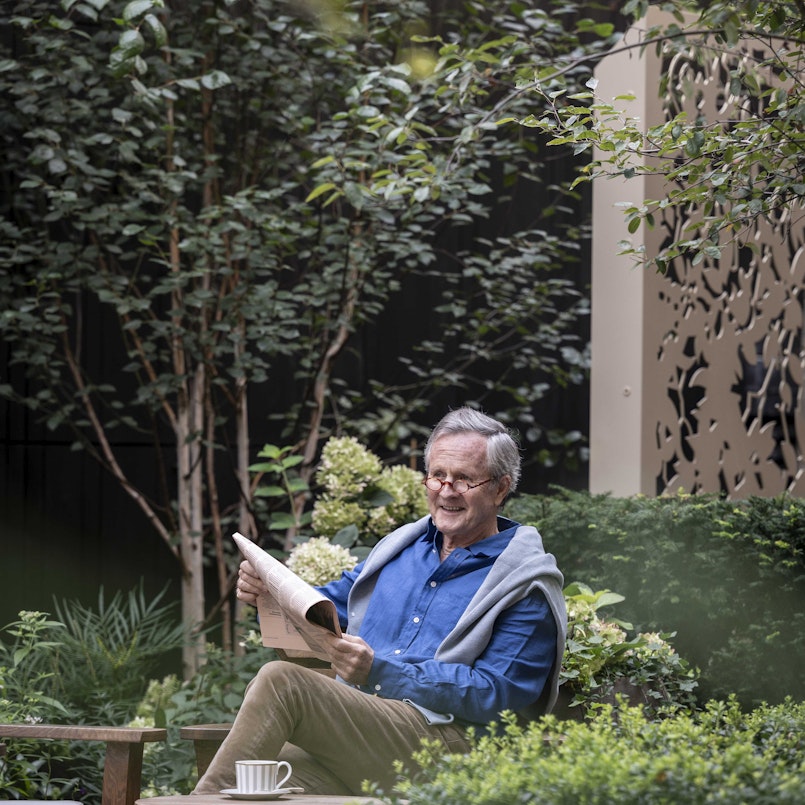 Reading a newspaper in the garden