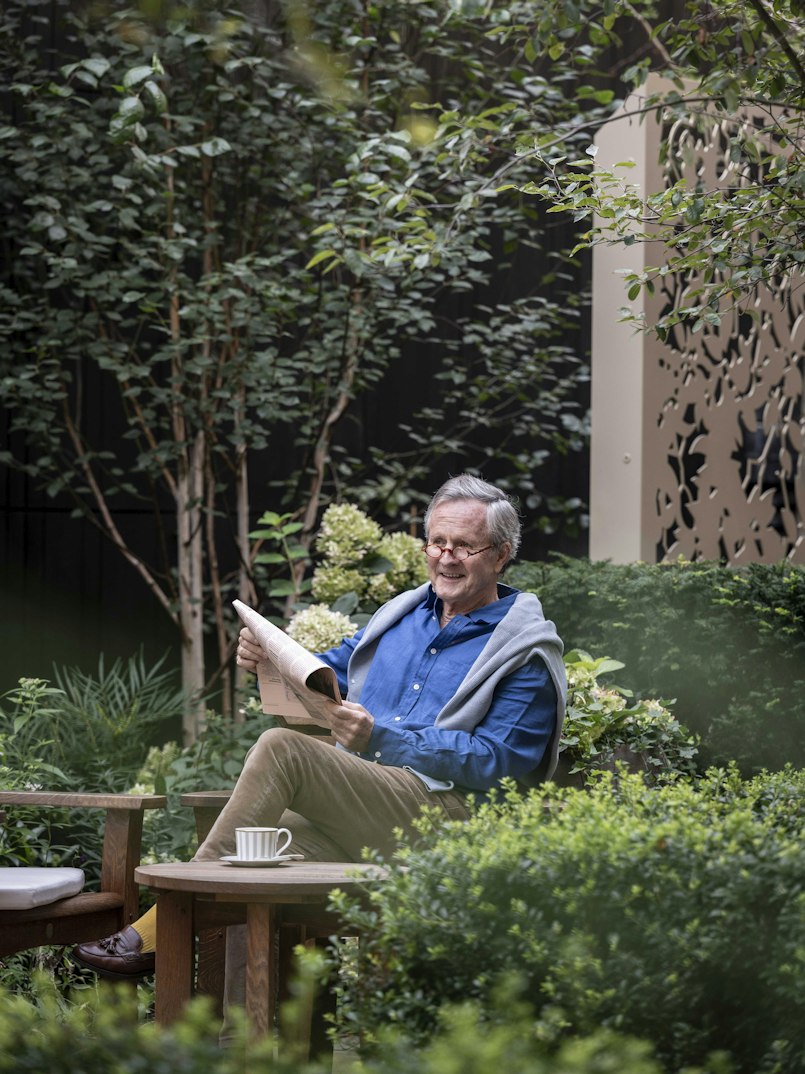 Reading a newspaper in the garden