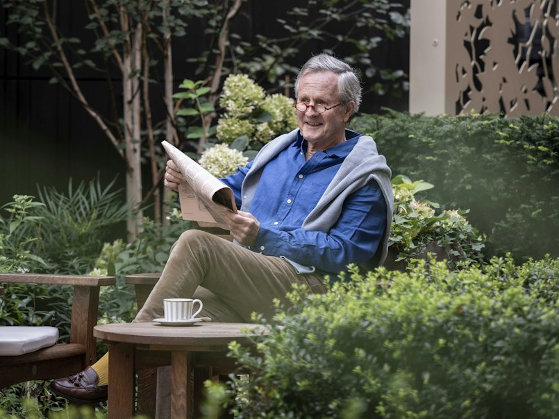 Reading a newspaper in the garden