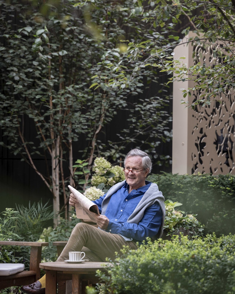 Reading a newspaper in the garden