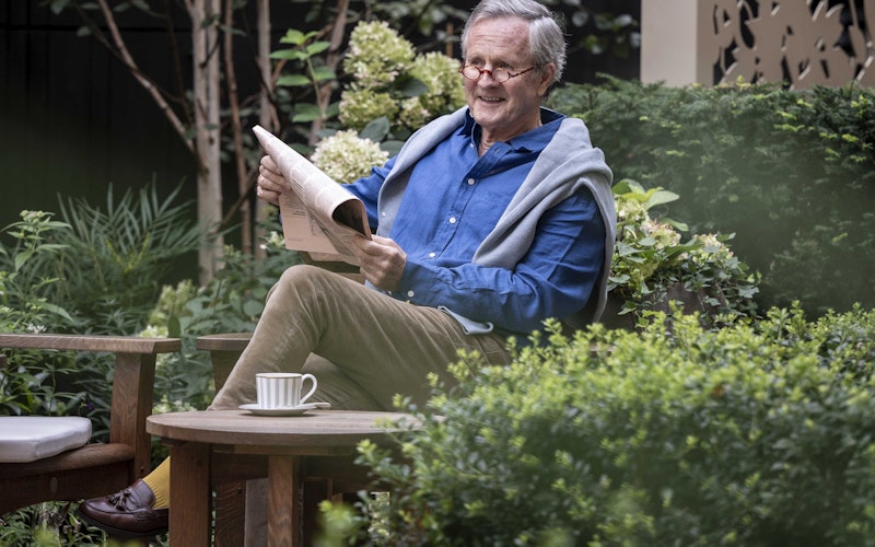 Reading a newspaper in the garden
