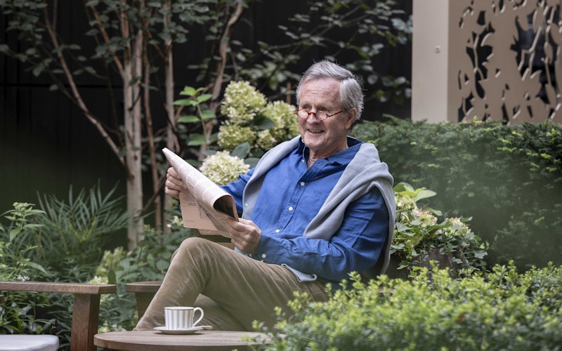 Reading a newspaper in the garden