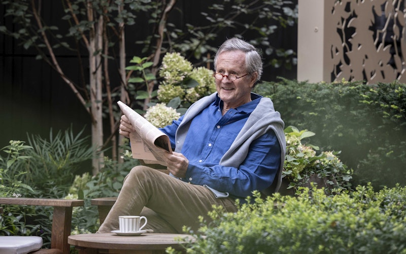 Reading a newspaper in the garden