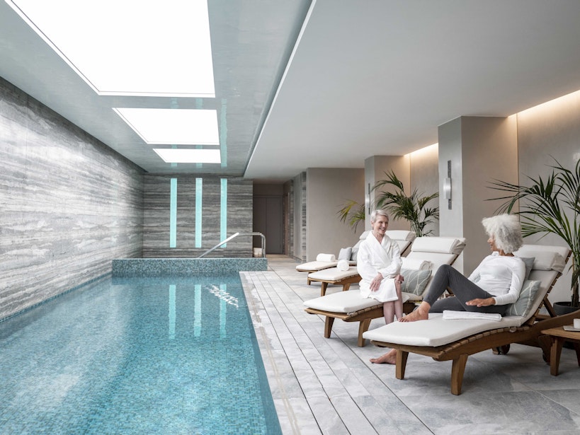 Women relaxing next to pool