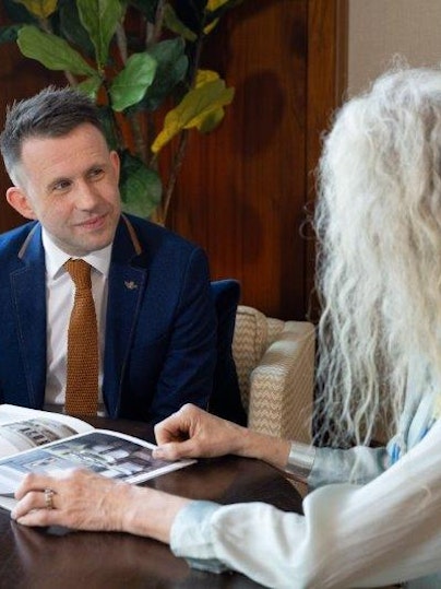 Sales advisor and customer looking at a brochure