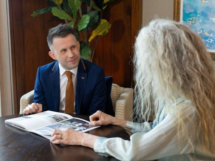Sales advisor and customer looking at a brochure