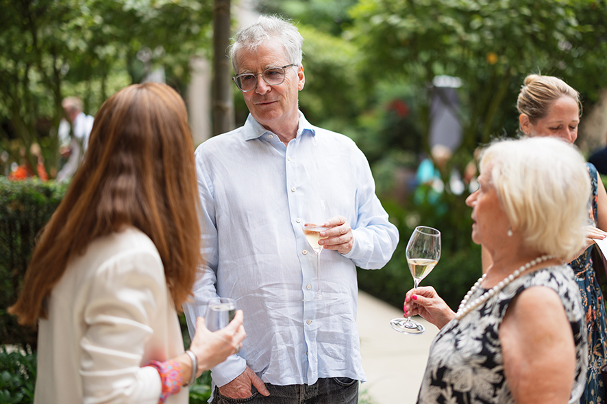 Guests mingling at the summer party