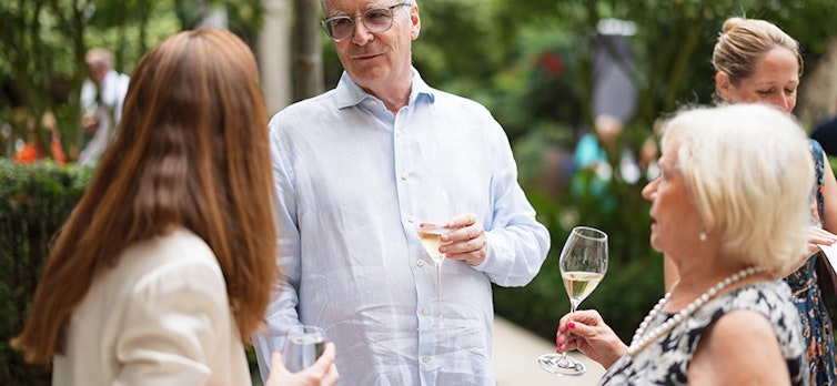 Guests mingling at the summer party