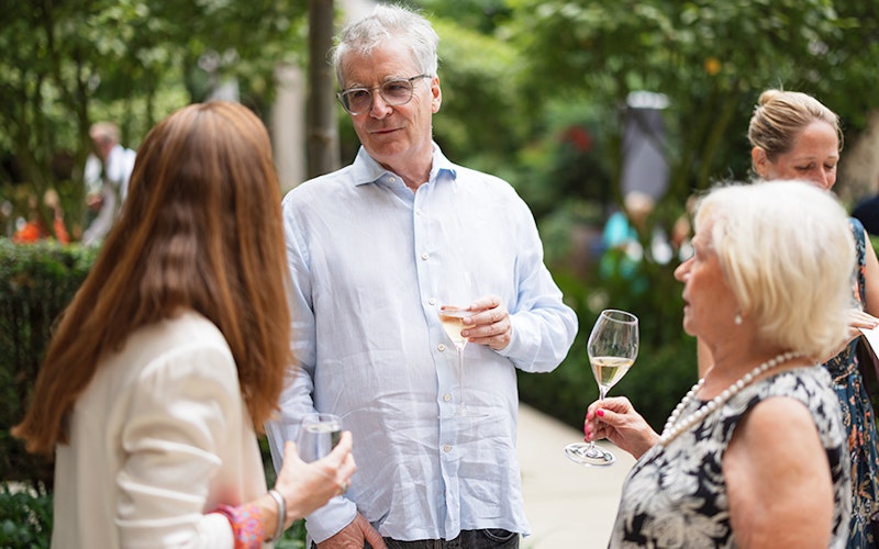 Guests mingling at the summer party