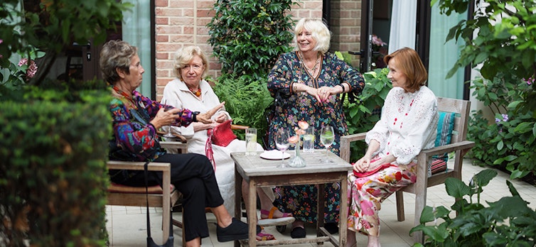 A group of friends catching up in the garden