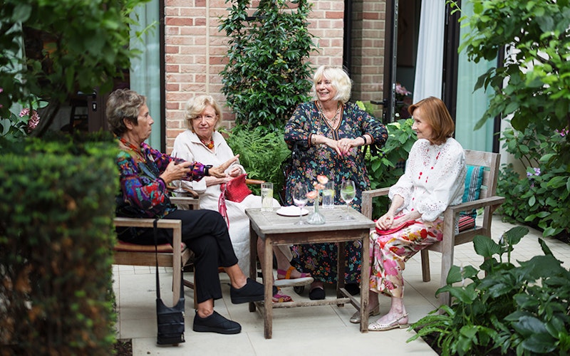 A group of friends catching up in the garden