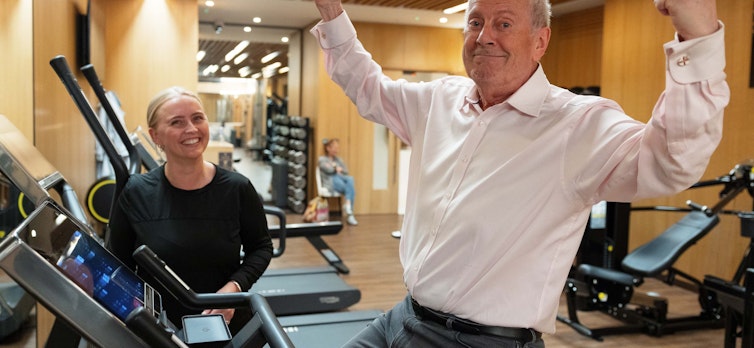 Gyles Brandreth with a personal trainer in the gym