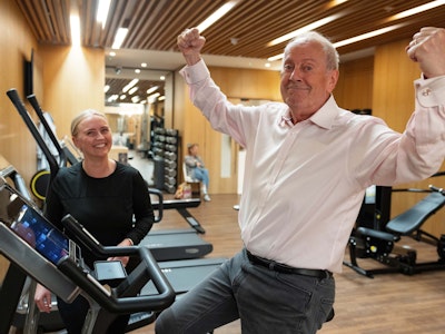 Gyles Brandreth with a personal trainer in the gym