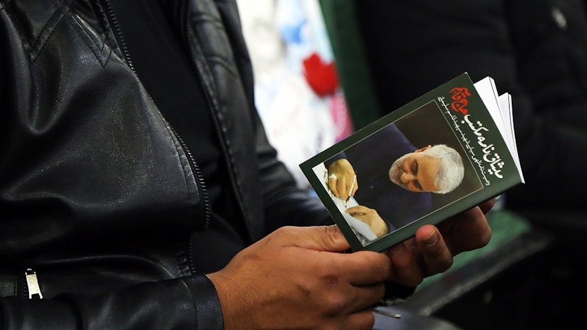 A man holding a book containing Soleimani’s will on the first anniversary of his assassination, Sanandaj, Iran Jan 8, 2021. (Photo via Fars News Agency)